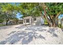 Updated home featuring new paint, a gravel yard, and mature landscaping at 8504 N 17Th St, Tampa, FL 33604