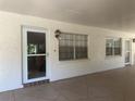 Covered patio with tile flooring, door, windows and outside lighting at 861 Maple Ct # 104, Dunedin, FL 34698