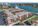 An aerial view of the condo with serene water views, nearby parking and exterior balconies at 8931 Blind Pass Rd # 360, St Pete Beach, FL 33706