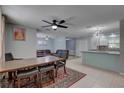 Open dining area with a rustic table and chairs flowing into a comfortable living space and kitchen at 9240 53Rd N Way, Pinellas Park, FL 33782