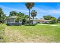 Charming single-story home boasts a well-maintained lawn and mature palm trees at 105 N Comet Ave, Clearwater, FL 33765