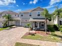 Charming two-story home featuring a three-car garage, paver driveway, and well-manicured landscaping at 10560 Lake Seminole Ter, Seminole, FL 33772