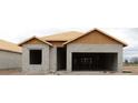 Home under construction featuring concrete block walls and roof framing, showcasing the building process at 10657 Crescent Creek Xing, Parrish, FL 34219
