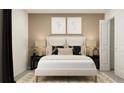 Cozy main bedroom featuring a plush white bed with decorative pillows and stylish nightstands with lamps at 11844 Blue Diamond Trl, Parrish, FL 34219
