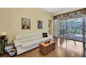 Comfortable living room with wood floors and view to the lanai at 12012 Cromwell Way, Spring Hill, FL 34609