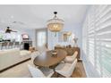 Bright and airy living room with a dining area, modern lighting, and comfortable seating at 1210 Bay Palm Blvd, Indian Rocks Beach, FL 33785