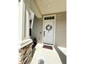 Inviting front entryway featuring a charming wreath, and stone pillar accents creating a warm and welcoming curb appeal at 12334 Country White Cir, Tampa, FL 33635
