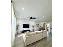 Bright and airy living room with modern decor, featuring hardwood floors and a comfortable, inviting atmosphere at 12334 Country White Cir, Tampa, FL 33635