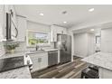 Modern kitchen features sleek stainless steel appliances and bright white cabinets and countertops at 1459 Joel Ln, Clearwater, FL 33755