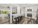 A modern kitchen with an island, stainless steel appliances, white cabinets and countertops at 1459 Joel Ln, Clearwater, FL 33755