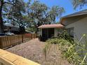 Fenced backyard features a screened porch and newly installed wooden fence for privacy at 14725 Morning Dr, Lutz, FL 33559