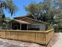 Well-maintained home showcasing a newly installed wooden fence surrounding the property at 14725 Morning Dr, Lutz, FL 33559