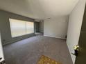 Bright living room featuring neutral carpet, freshly painted walls, and large windows at 14725 Morning Dr, Lutz, FL 33559