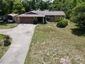 Charming single-story home featuring a stone facade, driveway, and well-maintained lawn at 17830 Simmons Rd, Lutz, FL 33548
