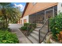 Inviting entrance with a screened-in porch and easy access via concrete steps at 1799 Dixie Hwy, Tarpon Springs, FL 34689