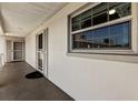 Exterior hallway view showing condo window and entrance door at 19029 Us Highway 19 N # 5-16, Clearwater, FL 33764