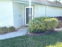 Inviting front entrance with beautifully landscaped garden featuring lush green bushes and an accent walkway at 19420 Haskell Pl, Land O Lakes, FL 34638