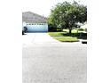 Charming home featuring a well-maintained two-car garage and extended driveway with lush lawn at 19420 Haskell Pl, Land O Lakes, FL 34638