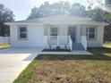 Inviting single-Gathering home with a covered porch, freshly painted, and modern design elements at 21033 Market St, Dade City, FL 33523