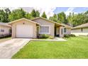 Charming single-story home with a well-manicured lawn and inviting front garden at 2818 Cedaridge Dr, Tampa, FL 33618