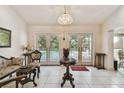 Open living room with tile floors and french doors to the pool area at 2901 50Th E Pl, Bradenton, FL 34203