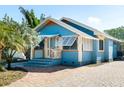 Charming exterior of a blue single-story home with a cozy front porch at 3108 Dupont S St, Gulfport, FL 33707