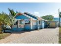 Lovely blue home exterior with a brick driveway and a detached garage at 3108 Dupont S St, Gulfport, FL 33707