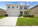 Charming two-story home with a well-maintained lawn and attached garage at 33524 Elm Hill Br, Wesley Chapel, FL 33545