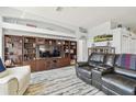 Spacious living area featuring a custom built-in entertainment center and comfortable seating at 3737 Gaviota Dr, Sun City Center, FL 33573
