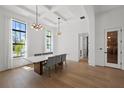 Elegant dining room with tray ceiling, modern lighting, and large windows at 403 E Davis Blvd, Tampa, FL 33606