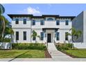 Stunning two-story home with black trim, elegant landscaping, and a welcoming entrance at 403 E Davis Blvd, Tampa, FL 33606