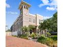 Inviting home exterior boasting a tower, brick driveway, and meticulously landscaped front yard at 407 S Fremont Ave # B, Tampa, FL 33606