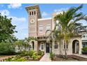 Charming home exterior with a tower feature, inviting front entrance, and lush landscaping at 407 S Fremont Ave # B, Tampa, FL 33606