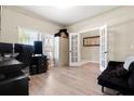 Versatile home office space featuring a large window, neutral walls, and hardwood floors at 4917 Eagle Rock Dr, Wimauma, FL 33598