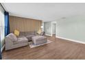 A spacious living room featuring a comfortable gray sectional with modern flooring at 502 Timber Bay E Cir, Oldsmar, FL 34677