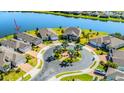 Aerial view of a neighborhood featuring a central roundabout and waterfront homes at 5090 Caravel Pt, Land O Lakes, FL 34638