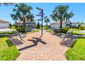 Charming community area with benches and lush landscaping, perfect for relaxation at 5090 Caravel Pt, Land O Lakes, FL 34638