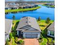 Beautiful single Gathering home with a well-manicured lawn and a tranquil water view at 5090 Caravel Pt, Land O Lakes, FL 34638