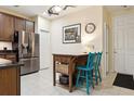 Eat-in kitchen with stainless steel refrigerator, breakfast bar, and modern finishes at 542 Harbor Ridge Dr, Palm Harbor, FL 34683