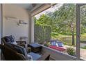Relaxing screened-in patio overlooking lush greenery and a serene pond at 542 Harbor Ridge Dr, Palm Harbor, FL 34683