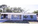 Charming one-story home featuring a brick facade, covered entrance, and well-maintained landscaping at 5608 Larimer Dr, Tampa, FL 33615