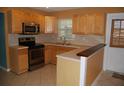 Cozy kitchen featuring wooden cabinets, stainless steel appliances, and an eat-in breakfast bar at 6326 55Th N Ave, St Petersburg, FL 33709