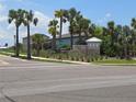 View of the Shell Cove community sign surrounded by lush landscaping and mature palm trees at 742 8Th Nw St, Ruskin, FL 33570