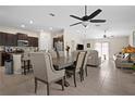 Open concept living space with kitchen, dining area, and living room with tile floors throughout at 742 8Th Nw St, Ruskin, FL 33570