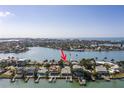 Stunning aerial view of a waterfront home with a boat dock and beautiful water views at 811 Bay Point Dr, Madeira Beach, FL 33708