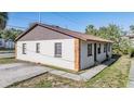 Exterior view of home showing siding, windows, and driveway at 8317 N Marks St, Tampa, FL 33604