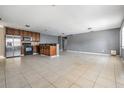 Open-concept kitchen with tile flooring and stainless steel appliances at 8317 N Marks St, Tampa, FL 33604