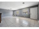 Spacious living room with neutral gray walls and tile floors at 8317 N Marks St, Tampa, FL 33604