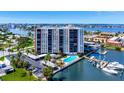 Scenic view of the condo building with a pool, boat docks and waterfront access at 10355 Paradise Blvd # 502, Treasure Island, FL 33706