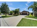 Charming single-Gathering home with a well-maintained lawn, long driveway, and attached two-car garage at 11121 Hudson Hills Ln, Riverview, FL 33579